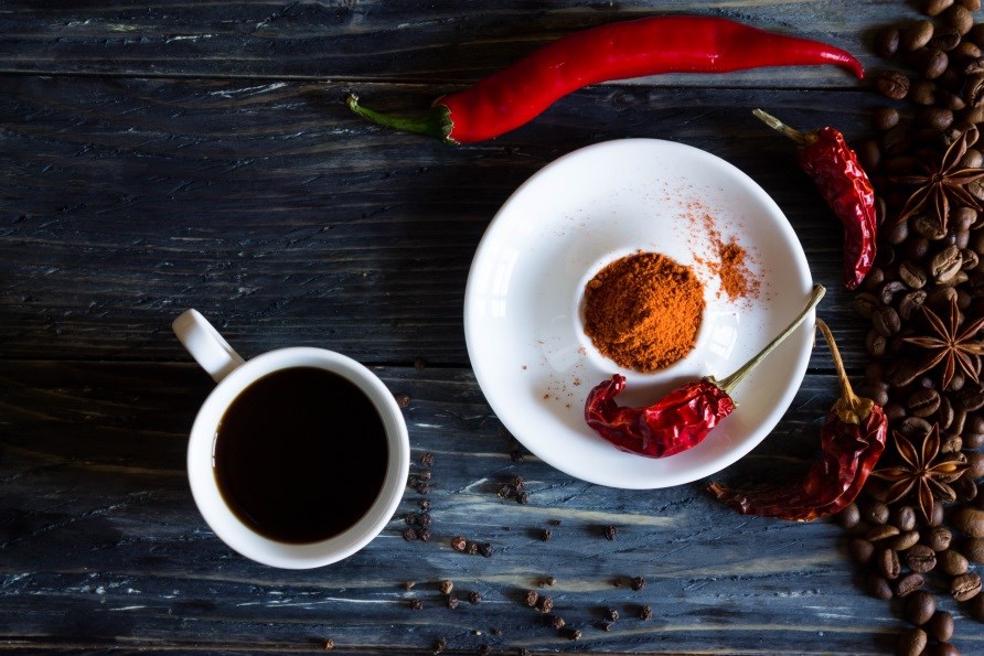 Kahvia ja chilipaprikoita pöydällä. Kahvia ja chilipaprikoita pöydällä.